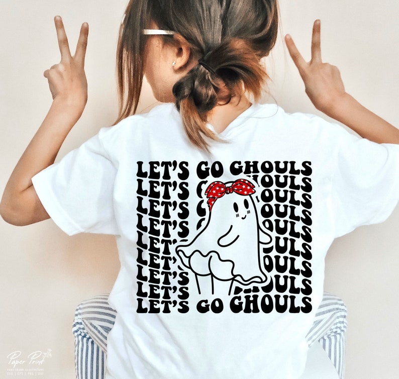 May include: White t-shirt featuring a black and white graphic of a ghost wearing a red bandana. The text "Let's Go Ghouls" is repeated in a retro font.