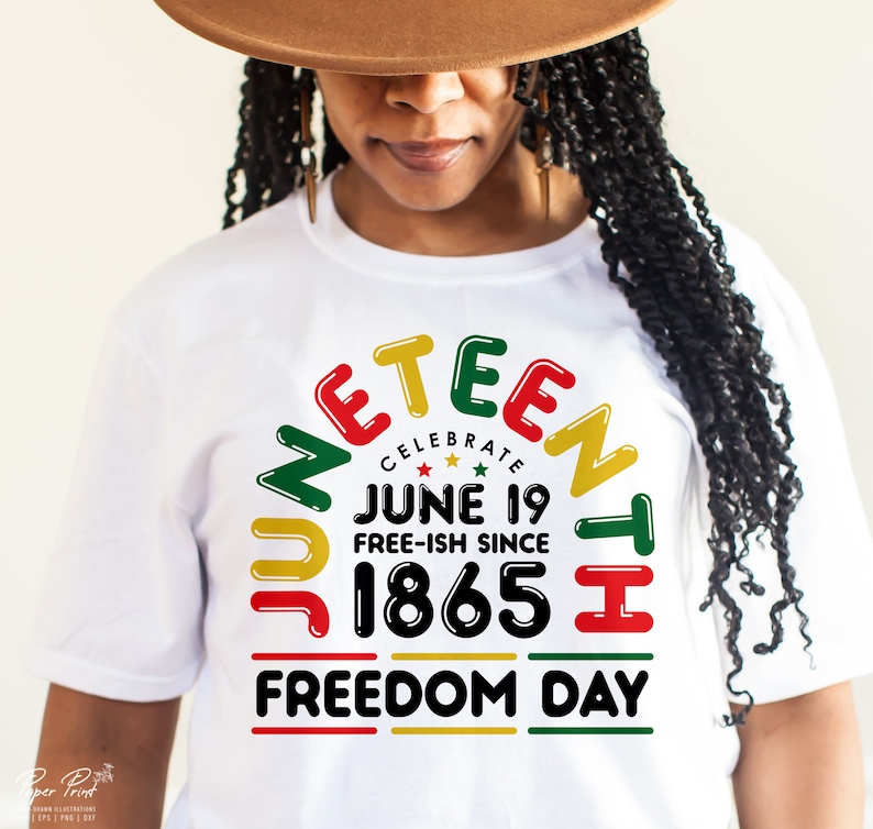 May include: White t-shirt with a graphic design that says "Juneteenth Celebrate June 19 Free-ish Since 1865 Freedom Day". The graphic is in a rainbow of colors, red, yellow, green, and black.