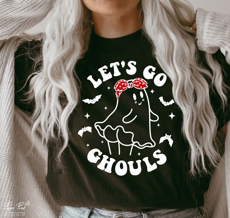 May include: Black t-shirt with a white graphic of a ghost wearing a red bandana and the text "Let's Go Ghouls".