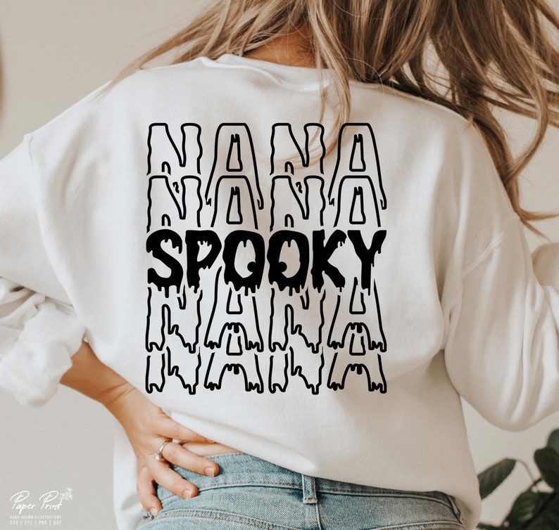 May include: White sweatshirt with a black graphic design that says "Spooky Nana" with the word "Nana" repeated three times.