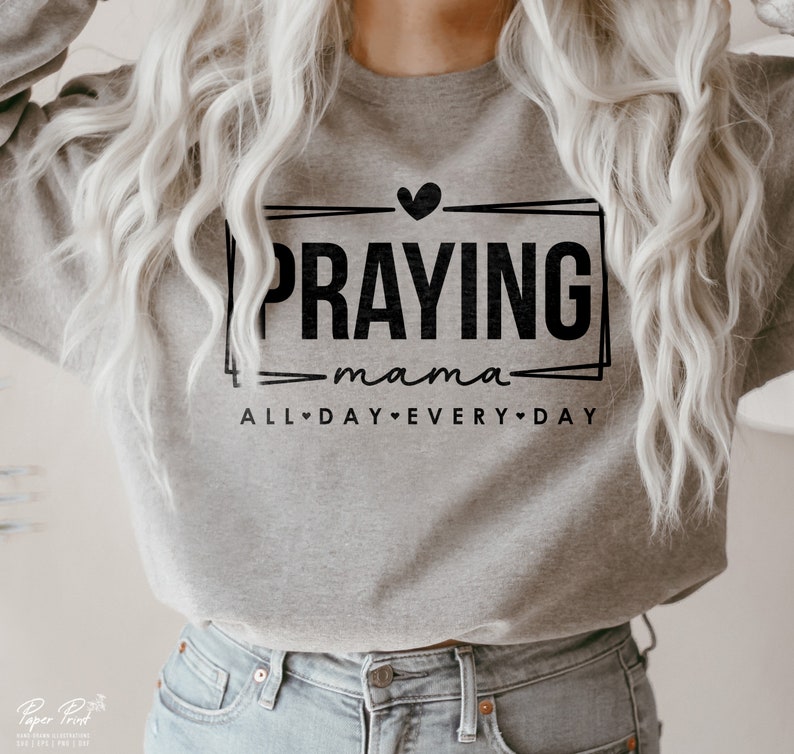 May include: Gray sweatshirt with black text that reads "Praying mama all day every day" with a heart symbol between each word.