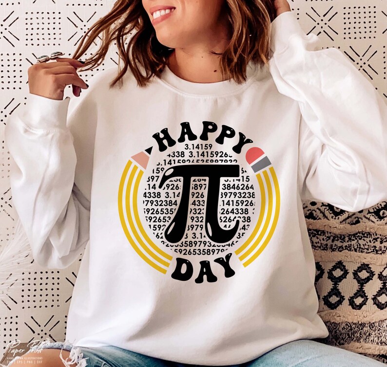 May include: White sweatshirt with a graphic design of a black pi symbol surrounded by yellow and orange concentric circles. The text "HAPPY PI DAY" is written in black above and below the pi symbol. The graphic also includes numbers related to the mathematical constant pi.