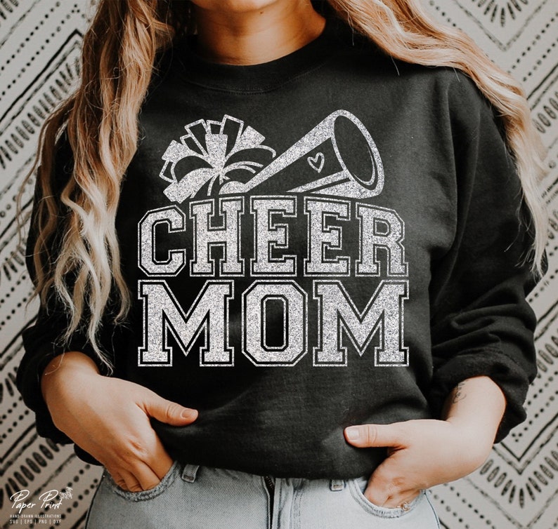May include: Black sweatshirt with a silver glitter design of a cheerleader megaphone and the words "CHEER MOM".