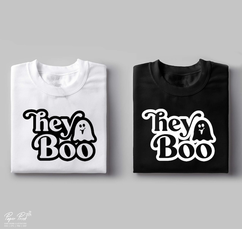 May include: Two folded t-shirts with a black and white graphic design. The design features the text "They Boo" with a ghost next to the word "Boo". One shirt is white and the other is black.