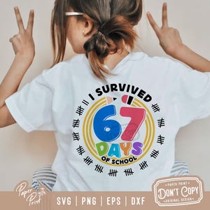 May include: White t-shirt with the text "I SURVIVED 67 DAYS OF SCHOOL" in a colorful design. The design includes a blue number 6, a red number 7, and the words "DAYS OF SCHOOL" in green and purple. The shirt also has tally marks around the design.
