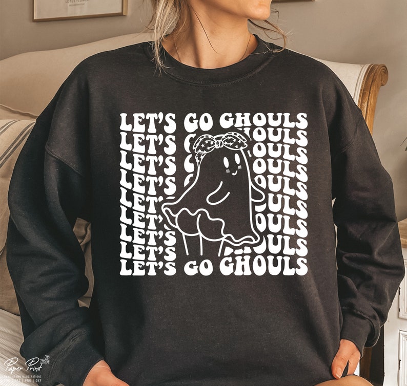 May include: Black sweatshirt with a white graphic of a ghost wearing a bandana and the text "Let's Go Ghouls" repeated in a retro font.
