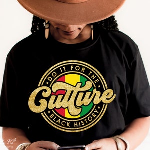 May include: Black t-shirt with a gold glitter circle design that says "Do it for the Culture Black History". The circle design features a red, yellow, and green flag.