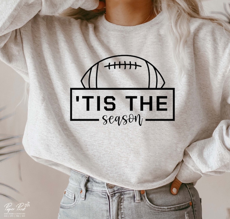 May include: A gray sweatshirt with a black graphic of a football and the text 'Tis the season'.