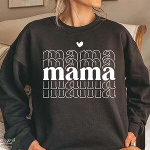 May include: Black sweatshirt with a white graphic design that says "mama" in a retro style with a small heart above the word.