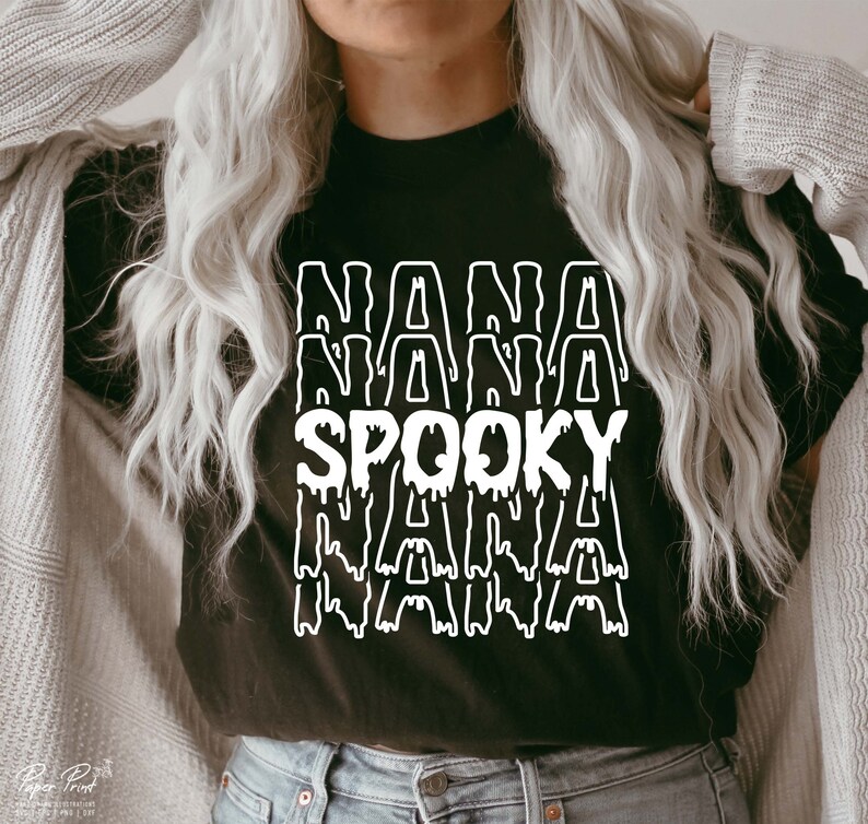 May include: Black t-shirt with a white graphic that says "NANA SPOOKY NANA" in a dripping font.