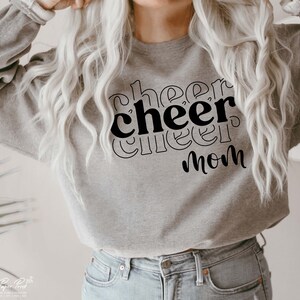 May include: A grey sweatshirt with the text "cheer cheer mom" printed in black.