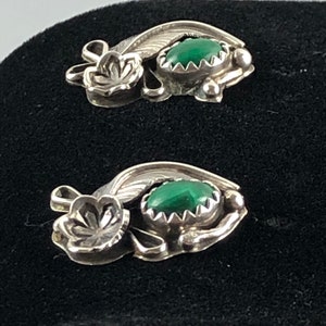 May include: A pair of sterling silver earrings featuring green malachite stones and floral designs.