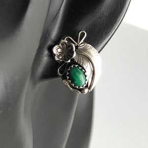 May include: Sterling silver earrings featuring a green malachite stone and a floral design.