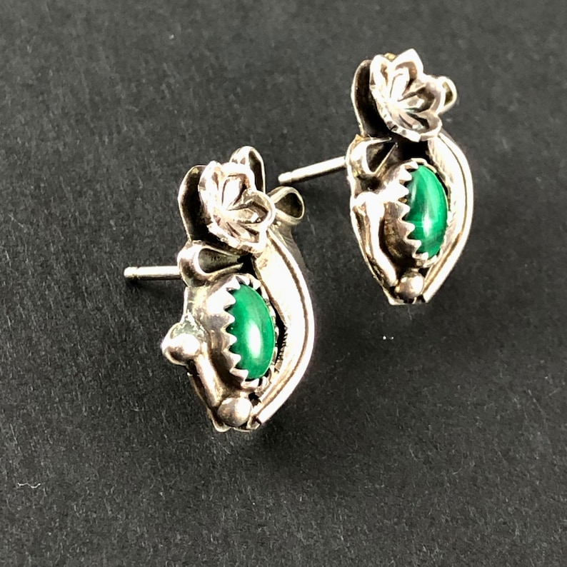 May include: Sterling silver earrings with green malachite stones and floral designs.