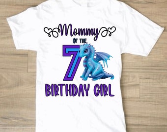 May include: White t-shirt with a purple and blue design. The design features a blue dragon, the number 7, and the text "Mommy of the 7 Birthday Girl".