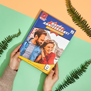 May include: A blue comic book cover with a photo of a couple on the front. The cover reads "Happy Anniversary!" and "Issue #1".