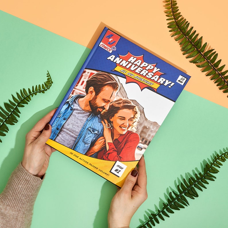 May include: A blue comic book cover with a photo of a couple on the front. The cover reads "Happy Anniversary!" and "Issue #1".