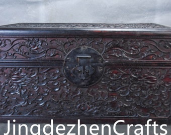 A large collection of hand carved Chinese antiques. It is decorated in a box with rosewood twigs and flowers