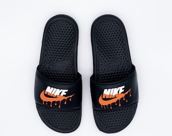 new nike slides with gold check