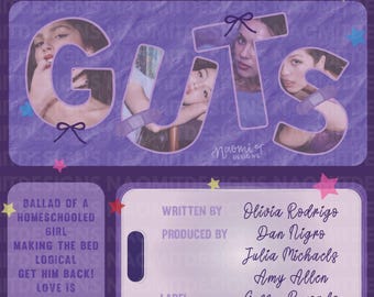 May include: Purple album art with the word "GUTS" in large letters, featuring images of a person's face within the letters. The album art includes song titles and credits, with the artist's logo at the top.