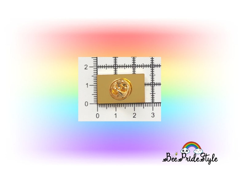 May include: A gold-colored rectangular pin with a butterfly design, measuring approximately 1 inch in length. The pin is set against a white grid background with rainbow gradient colors. The text "Bee Pride Style" is in the bottom right corner.