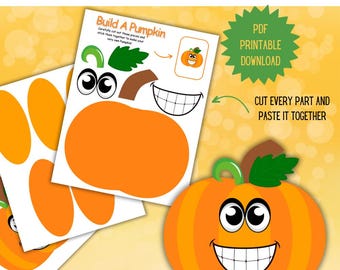May include: A craft kit for kids featuring a build-a-pumpkin activity. The kit includes orange pumpkin shapes, green leaves, and a smiling face. The text "Pumpkin Kid Craft" and "PDF Printable Download" are visible.