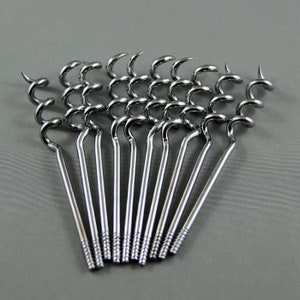 May include: A set of 12 silver-toned bottle openers with a corkscrew design. The openers are arranged in a fan shape.