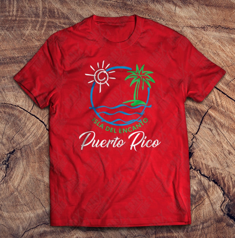 May include: Red t-shirt with a white and blue graphic of a sun, palm tree, and waves. The text "Isla del Encanto Puerto Rico" is written below the graphic.