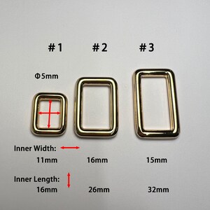 Peut inclure: Trois anneaux métalliques rectangulaires dorés de différentes tailles sont présentés sur fond blanc. Le plus petit anneau a une largeur intérieure de 11 mm et une longueur intérieure de 16 mm. Les deux autres anneaux sont plus grands, avec des mesures fournies.