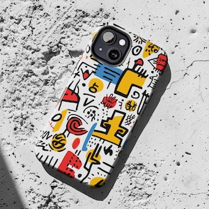 May include: A white phone case with a colorful abstract design. The design features geometric shapes, lines, and dots in red, yellow, blue, and black.