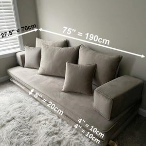 May include: A beige modular sofa with multiple cushions and armrests. The sofa measures 190cm long, 70cm wide, and 20cm thick. The cushions are 10cm thick. The sofa is on a fluffy white rug. The dimensions are displayed in inches and centimeters.