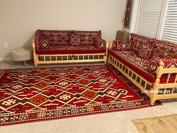 L-Shaped Floor Seating Sofa Set: Red Oriental Cushions & Wooden Bench