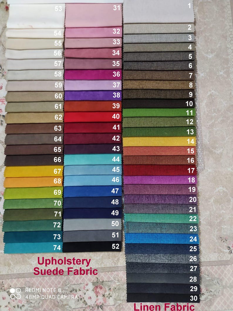 May include: A colour chart of upholstery suede and linen fabrics. The chart displays numerous fabric swatches in various colours, including pink, grey, green, blue, and brown. The text "Upholstery Suede Fabric" and "Linen Fabric" are visible at the bottom of the image.
