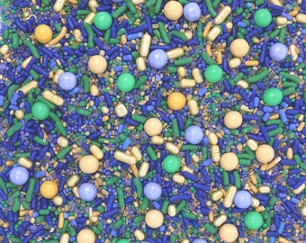 May include: A close-up image of a variety of colorful sprinkles. The sprinkles are a mix of blue, green, yellow, and gold. The sprinkles are perfect for decorating cakes, cupcakes, and other desserts.