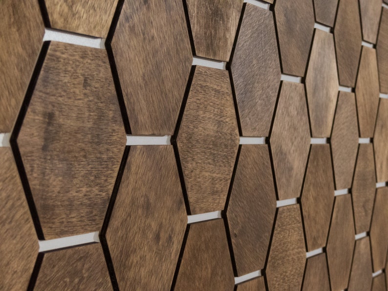 May include: A wall covered in a geometric pattern of brown hexagonal tiles. The tiles are arranged in a staggered pattern, creating a visually interesting texture.