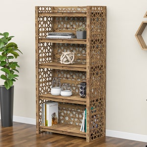 Puede incluir: Una estanter&iacute;a de madera con intrincados recortes geom&eacute;tricos. Los estantes est&aacute;n llenos de libros, plantas y objetos decorativos. La estanter&iacute;a es de color marr&oacute;n claro y tiene un dise&ntilde;o moderno.