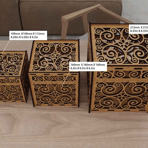 May include: Three wooden boxes with intricate swirl designs. The boxes are 4.29 inches, 6.3 inches, and 8.35 inches in size.