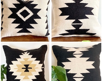 May include: Four square throw pillows with a geometric pattern in black, white, and beige. The pillows are made of a woven fabric and have a soft, plush texture.