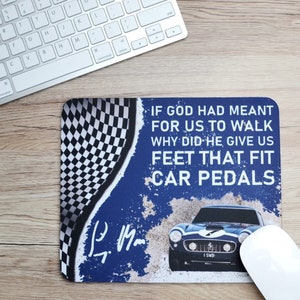 May include: Rectangular mousepad with a blue and white design. The mousepad features a vintage car illustration and the quote, "If God had meant for us to walk, why did he give us feet that fit car pedals?" A checkered flag design is on the left.