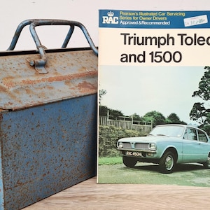 May include: A blue metal toolbox with a rusty patina and a vintage RAC Triumph Toledo and 1500 car repair manual. The manual is from Pearson's Illustrated Car Servicing series for owner drivers.