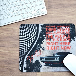 May include: A black and white checkered design mousepad with a black muscle car and the text "The most important thing in life will always be the people in this room right here right now".