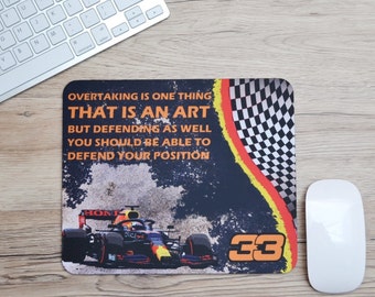 May include: Rectangular mousepad with a Formula 1 race car design. The mousepad features the text "OVERTAKING IS ONE THING THAT IS AN ART BUT DEFENDING AS WELL YOU SHOULD BE ABLE TO DEFEND YOUR POSITION". The design includes a checkered flag and the number 33.