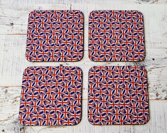 May include: Set of four square coasters with a repeating pattern of the Union Jack flag in red, white, and blue.