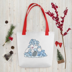 Puede incluir: Bolsa de tela blanca con asas rojas que presenta una ilustración de dibujos animados de un conejito blanco cubierto de cubitos de hielo azules.