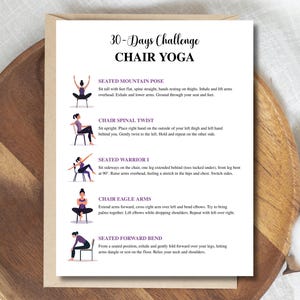 May include: A white paper with the text "30-Days Challenge Chair Yoga" and illustrations of yoga poses. The poses include Seated Mountain Pose, Chair Spinal Twist, Seated Warrior I, Chair Eagle Arms, and Seated Forward Bend. The paper is on a wooden surface.