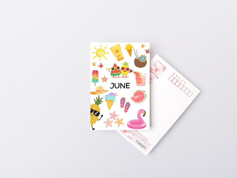 May include: A white postcard with a colorful illustration of summer icons, including a pineapple, watermelon, ice cream, sunglasses, and a flamingo float. The text "JUNE" is printed in black at the center of the postcard.
