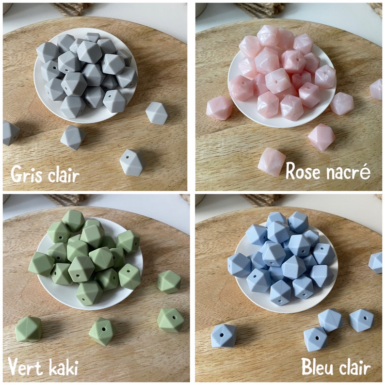 May include: Four sets of silicone teething beads in different colors: light gray, light pink, light green, and light blue. Each set is arranged in a pile on a small white plate, with a few extra beads scattered around the plate. The plates are on a wooden surface.