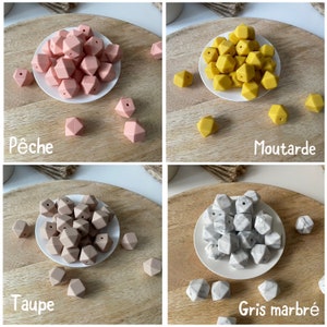 May include: Four sets of silicone teething beads in different colors: peach, mustard yellow, taupe, and gray marble. Each set is displayed on a white plate on a wooden surface.