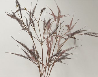 May include: A bunch of artificial pink and gray grass stems with feathery leaves.