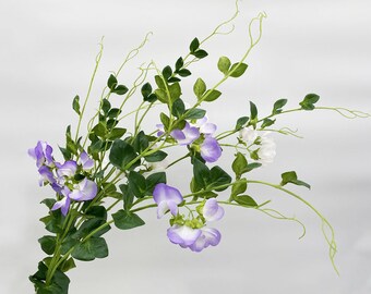 May include: A bouquet of artificial purple and white sweet pea flowers with green stems and leaves.